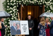 The moment I saw our faces plastered beside the sign “Do not let these two in!” my breath snapped. My husband whispered, “She really doesn’t want us here…” and something inside me shattered. We walked away in silence, leaving our daughter to the celebration she thought she wanted. Three hours later, her call came—voice shaking—“Mom… everything’s gone wrong.” And that was the moment her wedding truly ended.