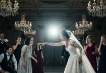 I was standing alone in the corner when the bride suddenly pointed at me and said, “Who let this beggar into my wedding?” The music stopped. Every face turned toward me. My hands shook, but I didn’t leave. Instead, I looked straight at her and said quietly, “You’re right. I don’t belong here… as a guest.” What happened next changed her perfect day forever.
