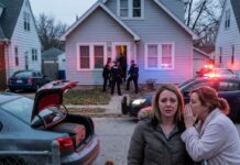 My husband told me he was going to spend a few days caring for his sick mother, so I buckled our five-year-old into the back seat, drove three hours to surprise him – and a neighbor grabbed my arm at the gate and whispered, “Don’t go in there. You need to know the truth.” Fifteen minutes later, police kicked in my mother-in-law’s front door, and the life I thought I’d built with the man I’d slept beside for seven years just… stopped. Standing there on that quiet Midwestern street with a suitcase in my trunk and my little boy rubbing sleep out of his eyes, I realized I was about to meet the real version of my husband for the very first time.