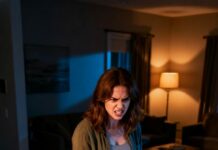 I was still holding the grocery bags when my husband’s voice drifted from the living room—soft, intimate. “Babe, come here.” I stepped closer, smiling… until I saw the framed wedding photo on the wall. Only it wasn’t our photo anymore. It was him—at the altar—kissing my best friend. My knees went weak. “What is this?” I whispered. He turned, pale, and said, “It’s not what you think.” Then why was my name missing?