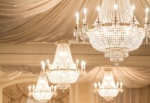 I felt the room turn cold when she leaned closer and whispered, “People like you should know their place.” Laughter rippled around the table. My hands trembled, but I stayed seated. Then my phone rang. “Are you ready, sweetheart?” my husband asked. I looked up just as the doors opened— and realized this night was about to change everything.