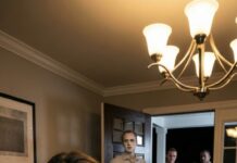 I sat at the family table with my arm in a cast, swallowing pain instead of dinner. My mother-in-law leaned back and smirked, “My son finally taught her a lesson.” His sister laughed, loud and proud: “She really thought she was in charge.” I didn’t argue—I just smiled. Thirty minutes later, the doorbell rang. My husband went pale. “Who… who is that?” he whispered. And that’s when everyone learned who truly runs this house.