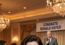 At my dad’s retirement party, he grabbed the mic and smirked, “This is my daughter—no degree, no future, just freeloading off the family.” Laughter exploded around me like fireworks. I didn’t blink. I smiled, подня my glass, and said, “Cheers—this is the last time any of you will ever see me.” The room froze. Silence swallowed the music. And as I walked out, my phone buzzed—one message that changed everything…