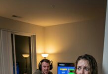 Nine months pregnant, I stagger up the stairs with grocery bags cutting into my swollen hands—sweat dripping, breath tearing. I push the door open and freeze: my husband gaming with his friends. He barks, “Don’t you know what time it is? Go cook!” I whisper, “I’m tired… just let me rest.” He lunges. “Stop acting!” A slap explodes across my face. I cook anyway. When I set the tray down, he opens it—then turns deathly pale. Because beneath the plates… lies the divorce paper. And this time, I’m not begging. I’m leaving.