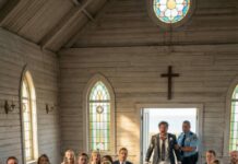 The music was still playing when the doors swung open—and I knew, with a sick kind of certainty, he wasn’t coming. My veil felt heavier than stone. Whispers sliced through the chapel. “Where’s the groom?” someone hissed. I stood there, abandoned at my own wedding… until my millionaire boss stepped beside me, eyes cold, jaw set. He leaned in and murmured, “Pretend I’m the groom.” Before I could breathe, he took my hand, raised it for everyone to see—and said something into the microphone that made my blood turn to ice. And that was only the beginning…