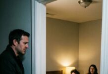 I didn’t scream when I found my wife curled into my brother’s arms. I smiled. “Close the door,” she whispered, eyes wide, voice cracking. My brother swallowed. “Wait—listen—” I turned the lock with a soft click and said, almost kindly, “Relax. I won’t ruin this.” They thought that was mercy. What she didn’t know was that every secret, every lie, every stolen dollar was already backed up—time-stamped, mirrored, impossible to erase. I walked away without a sound, because the loudest revenge is the one they never see coming. And tomorrow… I’ll give them a gift they can’t return.