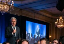 The ballroom glittered like a lie. I lifted my glass—smack. My cheek burned. Again. Again. Guests in silk pretended not to see as I clutched my belly and whispered, “Stop… I’m pregnant.” He leaned in, smiling for the cameras. “Then don’t embarrass me.” That’s when my father strode onto the stage, seized the mic, and said, “Everyone deserves the truth—about him, and about tonight.” Screens flickered on. And my husband’s face finally changed.