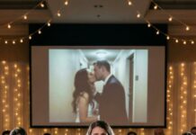 From my hotel room, I saw them in the hallway mirror—my sister’s hands on him, my fiancé’s mouth on hers. For a second my lungs forgot how to work. Then I heard her laugh: “Relax… she’ll never know.” I didn’t scream. I didn’t cry. I lifted my phone and hit Record. Because if they wanted a secret, I’d give them a spotlight. And on our wedding day… everyone would clap—for the truth.