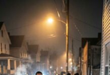 I stared at the crumpled bill in my palm—my last eight dollars—while he leaned against the wall, blood on his knuckles, a Hell’s Angel patch glaring like a warning. “Don’t,” my friend hissed. He lifted his eyes to me. “You don’t owe me anything, girl.” “I know,” I said, voice shaking, and slipped the cash into his hand anyway. His fingers tightened like he’d been handed a second chance. The next morning, my street thundered. Engines. Chrome. A hundred motorcycles rolling in like a storm. I froze on my porch as the leader stepped forward and called my name. “You helped one of ours,” he said, holding out a small box. “Now we’re here to return the favor.” When I opened it, my whole life tilted—yet what they asked for afterward was even more shocking…