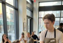 I was just a waiter—until I spilled coffee on a quiet billionaire’s sleeve and saw it: the same tattoo my mother hid for years. My stomach dropped. I leaned in and whispered, “Sir… my mother has that exact tattoo.” His face went ghost-white. Then he suddenly fell to his knees, gripping my wrist like he’d been waiting for me. “Where is she?” he rasped. And in that moment, I realized… my life wasn’t an accident.