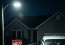 I dragged my suitcase up the driveway, craving sleep—until the gate wouldn’t budge. The house was dark. Empty. Then I heard a soft knock from a van at the curb. My mom’s voice cracked: “Don’t wake your father.” My stomach dropped. “Why are you in there?” Dad whispered, ashamed, “Your brother… said we had to go.” I stared at the “SOLD” sign. I smiled. “Okay,” I said. “Let’s play his game.” What happened next changed everything.