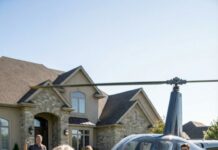 Smoke still clung to my clothes when I knocked on my daughter’s door. Her husband didn’t even let it open fully. “You’ll ruin my Persian rug,” he snapped, eyes cold. “I don’t shelter homeless women.” My throat burned—half from ash, half from shame. With shaking hands, I dialed a number no one knew I kept… the late neighbor’s boy I once raised like my own—now a billionaire. Minutes later, a helicopter thundered onto their lawn, and he stepped out, stared him down, and said three words…