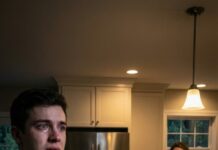 For forty years, an old man lived next door—and my parents treated him like a monster. They built a ten-foot fence, dragged him to court three times, and hissed, “He’s dangerous. Stay away.” But when he died, I was the only one at his funeral. After the last prayer, a lawyer approached me and whispered, “He left everything to you.” Then he slid the will into my hands… and I saw the first line.