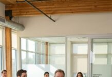 I walked into the architecture firm to surprise my son-in-law, and he smirked loud enough for everyone to hear: “Security—there’s a confused old man who wandered in. Can someone show him the exit?” The room filled with laughter. My face burned, but I stayed still. Then a door opened and the founding partner said, “Mr. Whitmore, your $22 million contract is ready… and Derek—pack your things.” I didn’t even blink.