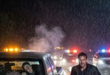 I still remember the exact moment everything changed on that dark highway. Rain was pouring, headlights blurred the road, and then I saw the wrecked truck smoking in the middle of the lane. A man was trapped inside, barely moving. Someone shouted behind me, “Don’t go near it, it could explode!” But I ignored them and ran forward. I grabbed the door and yelled, “Sir, can you hear me? Stay with me!” The smell of gasoline was everywhere. Then suddenly—a spark flashed under the hood. I had seconds to choose: run… or pull him out before the car turned into a fireball. What happened next still haunts me.