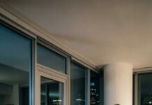 On our second wedding anniversary, I stood smiling beneath the lights and whispered, ‘I’m pregnant.’ The room froze—then my mother-in-law sneered, ‘You’re just desperate for attention!’ Before I could speak, she shoved me hard against the balcony rail. I remember screams, darkness… then a doctor’s grave voice in the hospital: ‘There’s something you need to know about this baby.’ And in that moment, my world truly began to shatter…