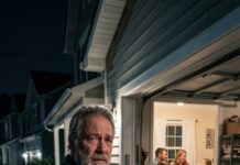 I watched my daughter drag my suitcase into the garage and say, “You’re on your own now, Dad.” I said nothing while my son-in-law’s family settled into my house like I no longer existed. The next night, they were laughing over dinner when my phone rang. I answered, heard one sentence, and felt the whole table turn cold. Suddenly, the house they had pushed me out of was about to become the last place any of them wanted to be.