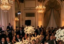 I was standing in my wedding dress, smiling for the cameras, when my father raised his glass and said into the microphone, “You’re making a mistake marrying a poor man.” The room laughed nervously, but I saw my husband’s face fall. I said nothing. I just let him finish. Because a few minutes later, I took that same microphone back—and told the guests the one secret my father had spent years begging me to keep