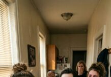 At Thanksgiving, my parents pulled me aside and hissed, “Don’t come in your restaurant uniform. Your sister’s new fiancé wants a classy dinner—your outfit will ruin the photos.” I swallowed my pride and whispered, “Okay… got it.” But the next morning they burst into my apartment, demanding answers. Then her fiancé saw me, went dead still, and said, “You… work there?” My stomach dropped—because he wasn’t surprised. He sounded caught.