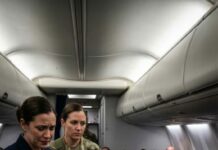 I was just an Army mechanic flying economy when two Navy officers had me kicked out of first class. One of them laughed and said, “Support staff shouldn’t sit up here.” I stayed quiet and walked back to row 29. But an hour later, smoke filled the cabin and the captain suddenly stepped out of the cockpit, scanning the passengers before calling my name: “Staff Sergeant Mercer, I need you up here—right now.” And in that moment, everyone who doubted me went silent.