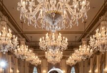 The wedding hall shimmered under the chandeliers and the sparkling champagne – white roses, violin music, two hundred guests smiling as if everything were perfect. Then my sister stormed onto the stage, snatching the microphone from the host. “I’m pregnant… with my sister’s husband’s child!” The clinking of plates, the silence, and all the cameras turned to me. I smoothed my veil and smiled. “Perfect timing.” Her face froze. She didn’t notice the “guest” near the aisle – a dapper suit, a calm gaze – raising his phone as the vows became the proof.