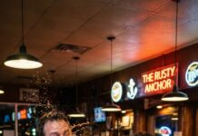 I never thought my life could shatter with one splash of whiskey. Emma stormed into the bar, eyes blazing. “Enough, Daniel.” She hurled her drink in my face—cold, burning—and slapped divorce papers onto the counter. “Sign. And don’t come home.” The room went silent as my pen trembled. I ran to my drinking buddies. “Just one couch… one favor.” Doors slammed. Phones died. Then my uncle handed me a card. “One million,” he said. “Use it to rebuild—or drown for good.” A year later, I returned in a suit, placing two million on his table. “I made it. Thank you.” He didn’t smile. He whispered, “It was never mine… or yours.” My blood froze. “What do you mean?” He leaned in. “Emma sold the house. The car. Everything. She gave me the money… to save you without letting you know.” I couldn’t breathe. I sprinted to the restaurant where she worked, heart cracking with every step. “Emma—please… I’m sorry. I didn’t deserve you.” She looked up, tired but steady. “I did it,” she murmured, “because I still believed in the man you buried.” And as she reached for my hand, one terrifying question hit me like another shot— can love really forgive… what it had to destroy to rescue you?