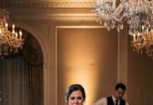 The moment my stepfather grabbed the microphone at my wedding and slurred, “You should be grateful I kept you fed,” I knew the night was about to explode. What started as a champagne toast turned into a public execution of my mother’s memory, a cut-off open bar, and a room full of 150 stunned guests watching my humiliation unfold. But when he hissed, “This company is mine,” he had no idea I was already holding the evidence that would destroy him. Three weeks later, he’d be in handcuffs on my lawn begging, “Millie, please,” and I’d finally understand what justice really tastes like.